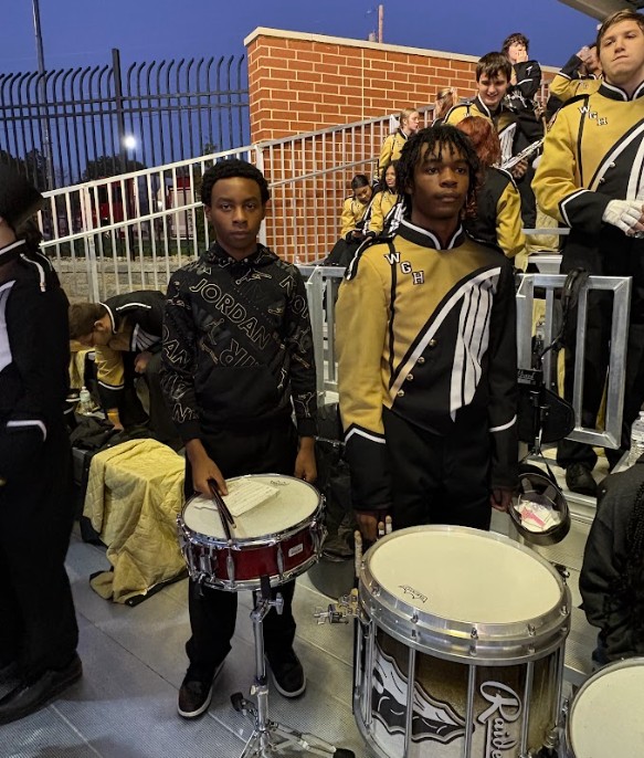 Joining in with his older brother in the band.