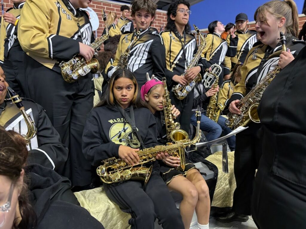 Sitting with current band members, ready to play.