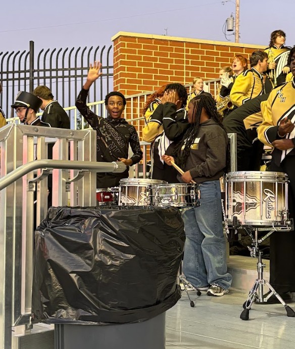 8th grade percussion students ready to cheer on the Raiders from the band shell.