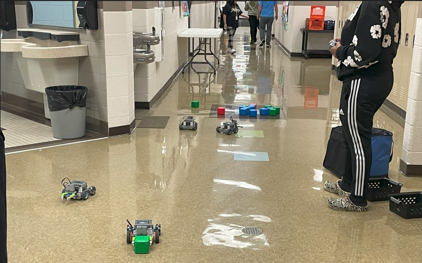 Robots grabbing and moving blocks.