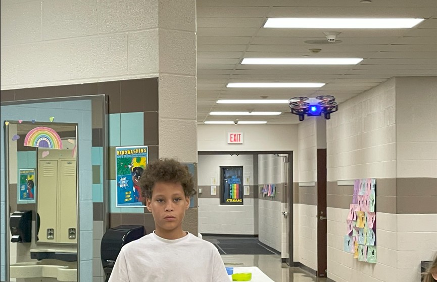 An 8th grader flying his drone.