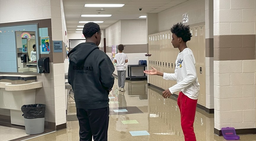 Two students controlling a drone.