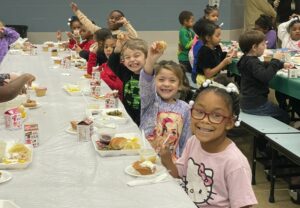 first graders enjoying their Thanksgiving feast