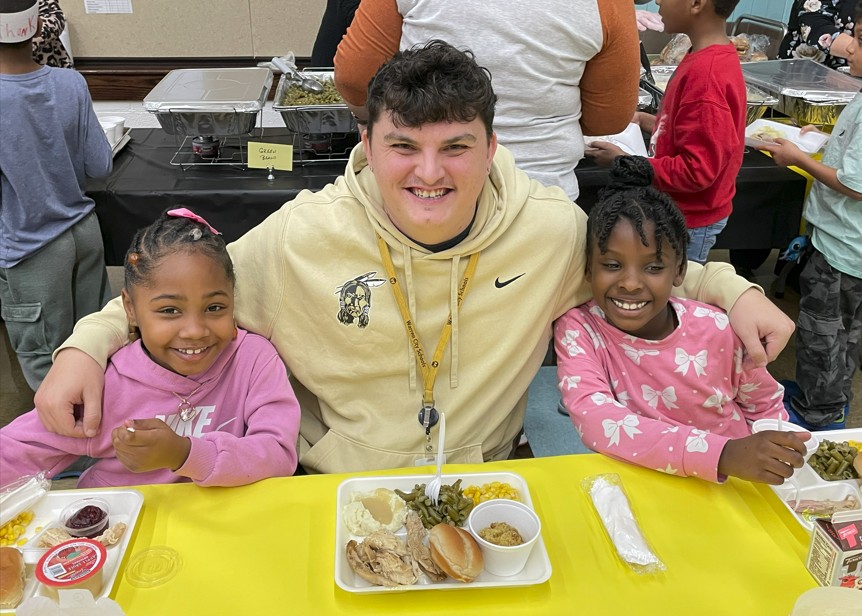 Coach Sheely enjoying lunch with a class.
