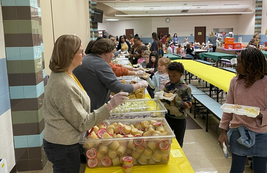 Volunteers and staff serving lunch.