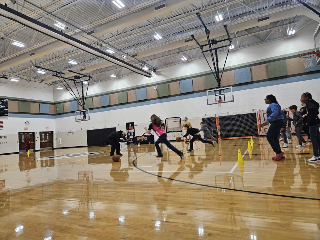 Students run basketball drills