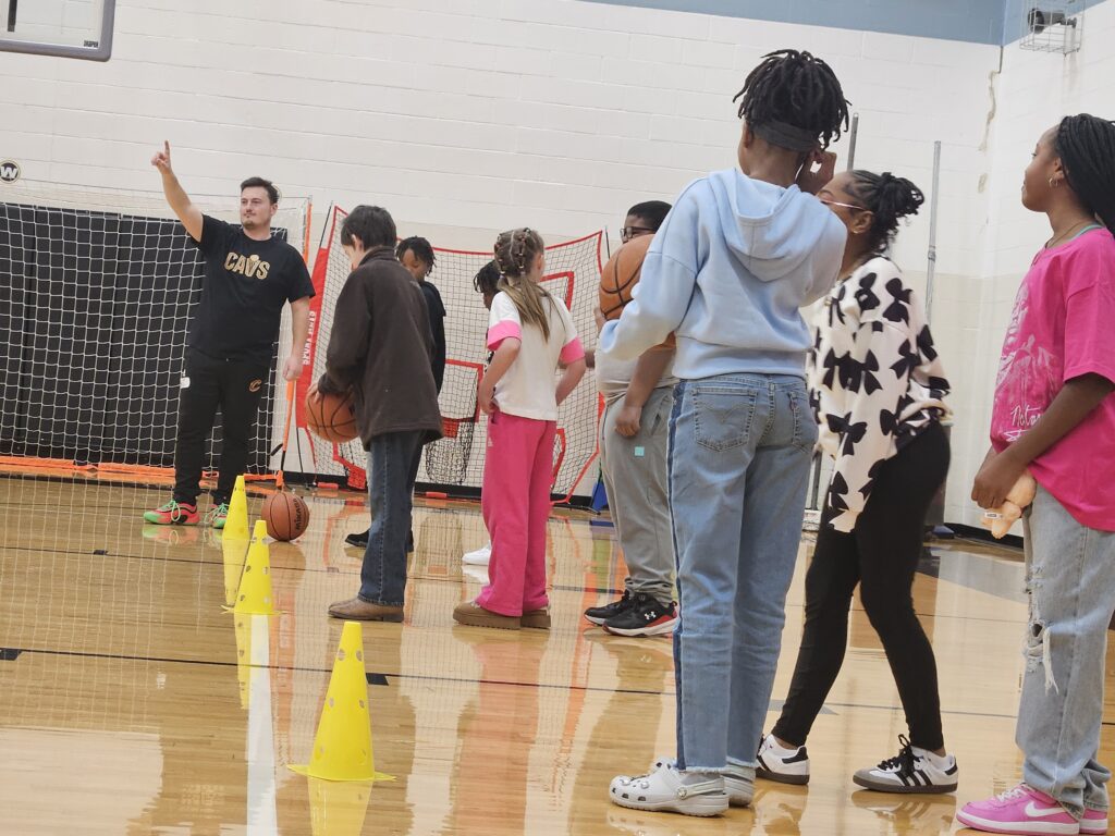 Students ready to run a basketball relay race