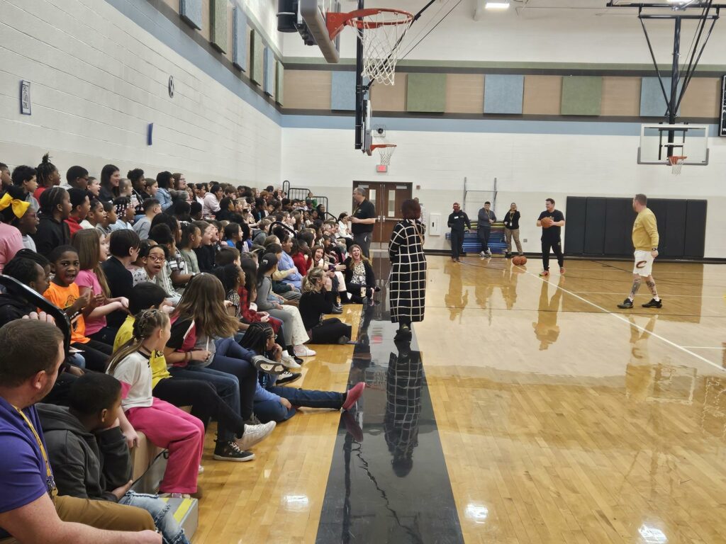 Students in the stands listening to the speaker