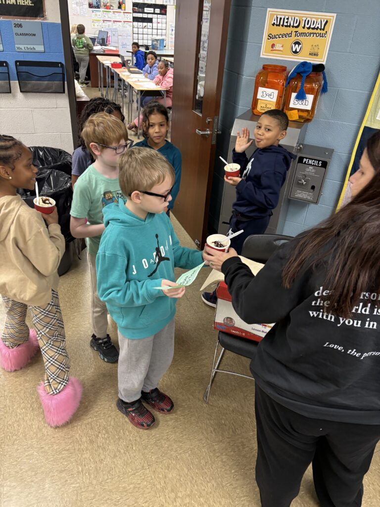 Students line up to receive their ice cream.
