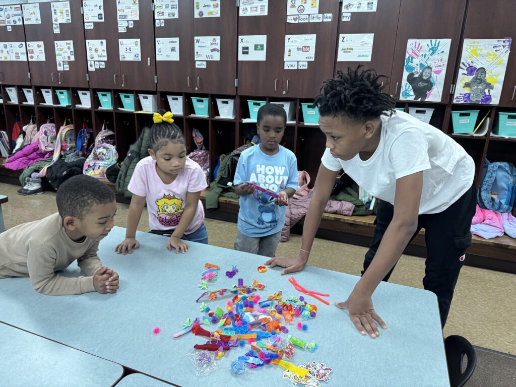 Students choose their reward with some help from an eight grade volunteer