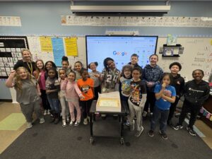 Mrs. Lasher's class standing with their cake