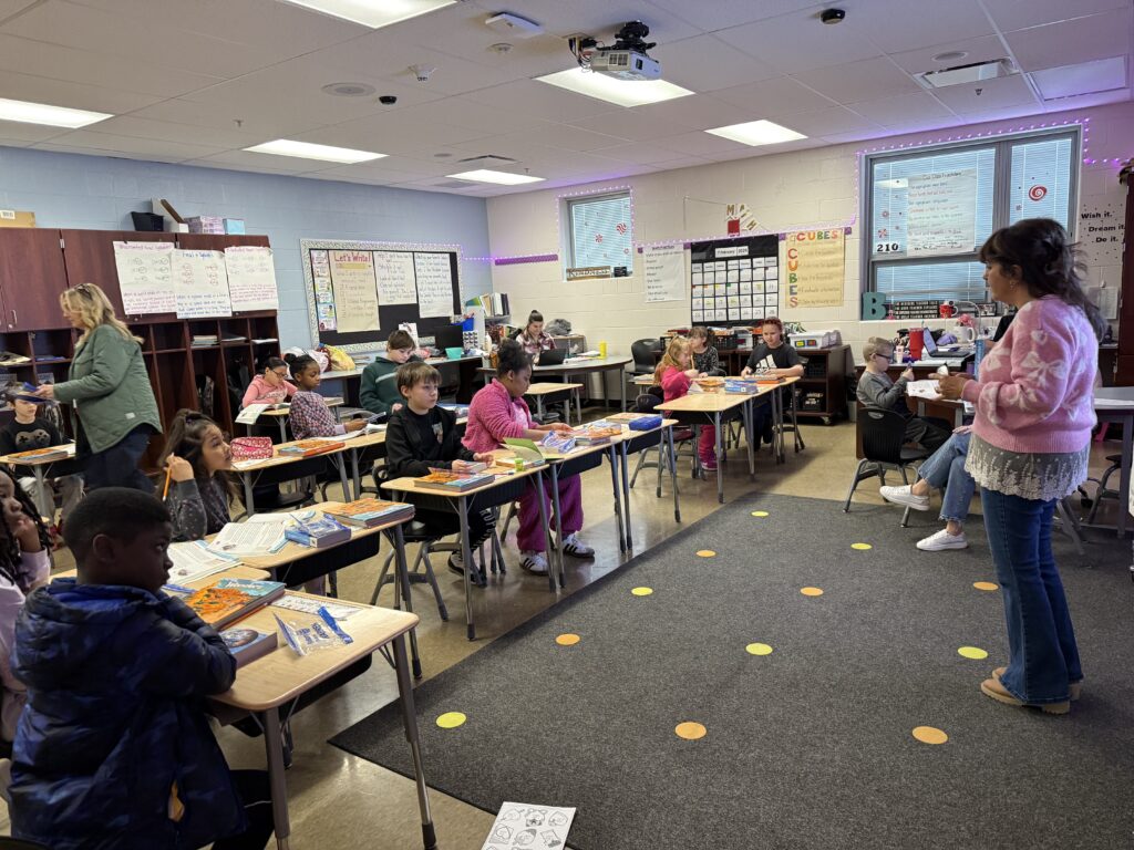Mrs. Lasher's class listens to a representative from the Rotary speak about their gift.