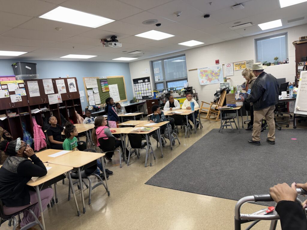 Students in Ms. Betts third grade class receive their dictionaries.