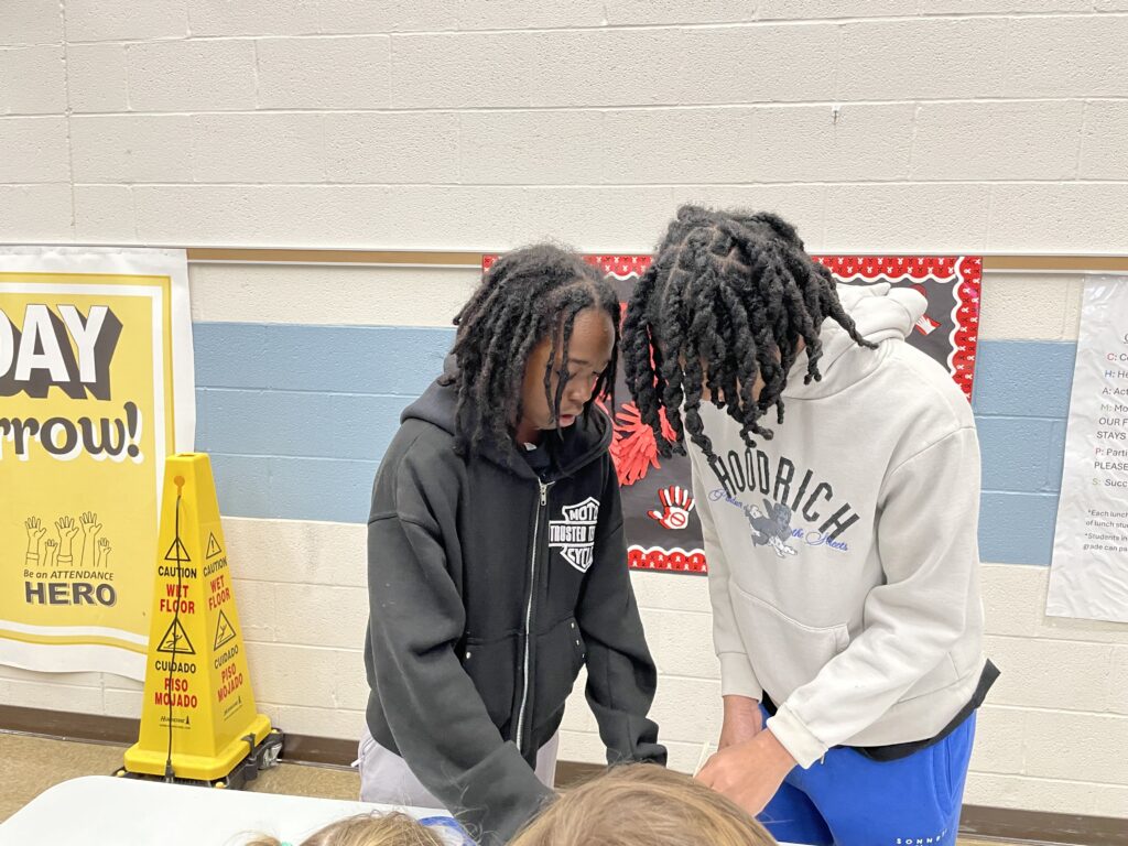 Middle school students work together.