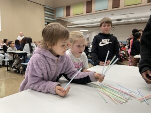 First graders talk about how they are going to build their tower.