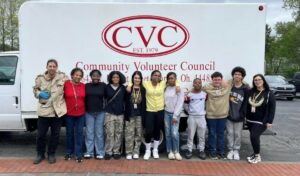 Student council stands in front of the community volunteer council truck