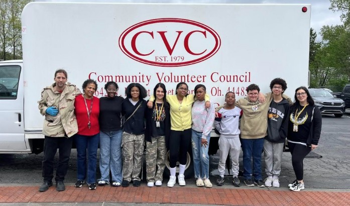 Student council stands in front of the community volunteer council truck