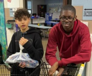 Students in grades 6-8 help sort and deliver fruits and vegetables to classrooms