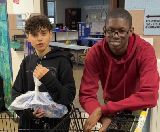 Students in grades 6-8 help sort and deliver fruits and vegetables to classrooms