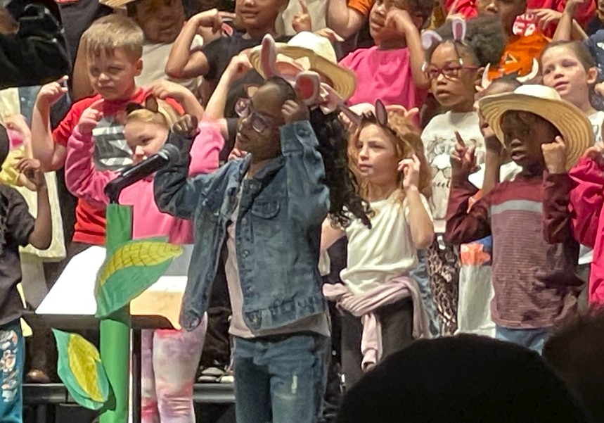 A soloist tells a joke as part of one of the songs