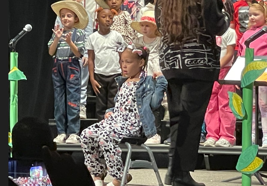 A student plays a cow in the musical