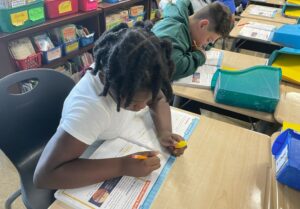 A fourth grader works hard on his assignment.