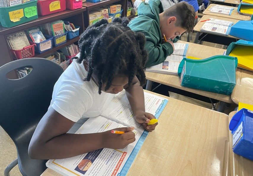 A fourth grader works hard on his assignment.