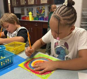 students working with oil pastels