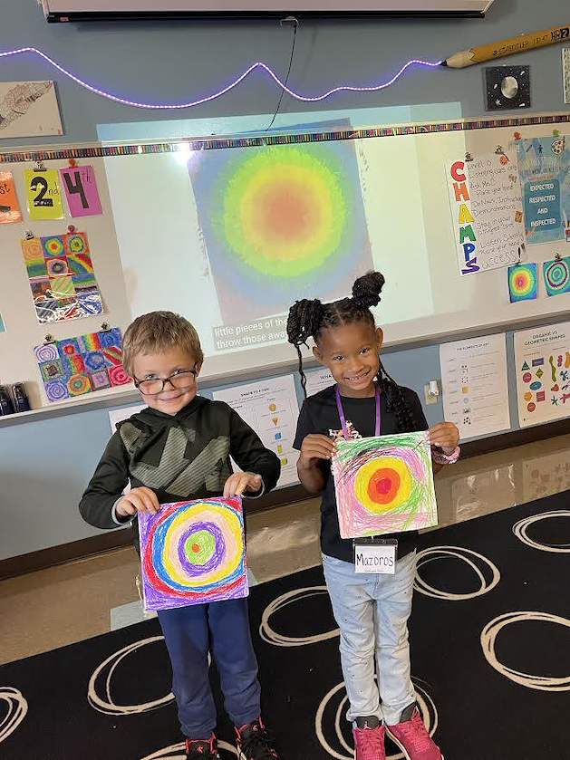Students show off their finished artwork
