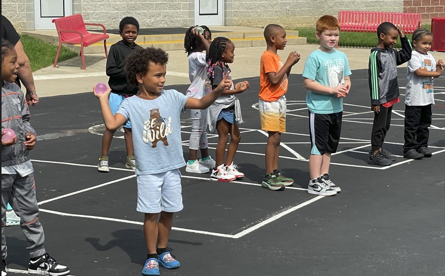 Students take turns throwing their water balloons
