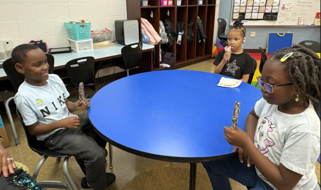 Students enjoy ice cream for having twenty days of perfect attendance